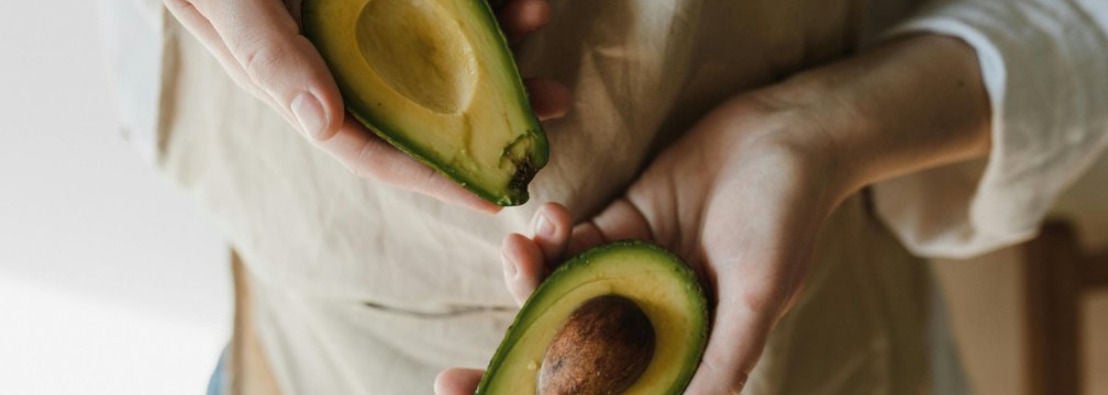 Deux moities d'avocat tenues dans des mains